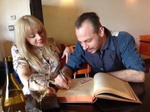Elaine and Francesco Palimieri signing Victoria Price's copy of the book during our lunch.